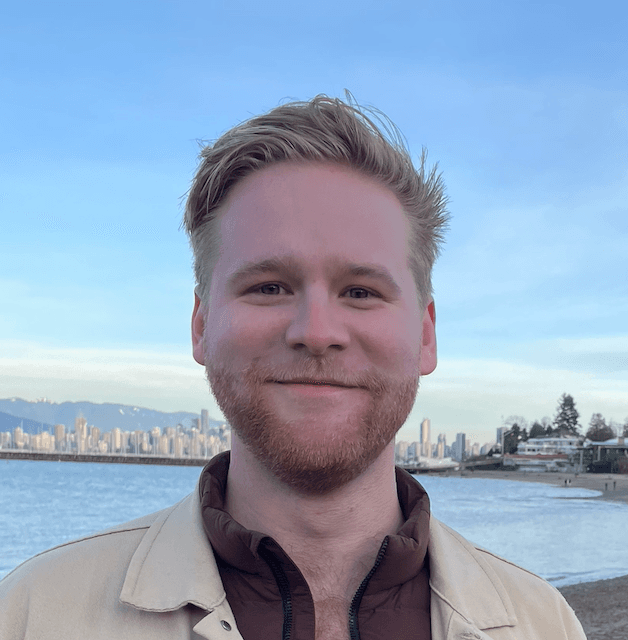 John Bryce smiling with a backdrop of Downtown Vancouver